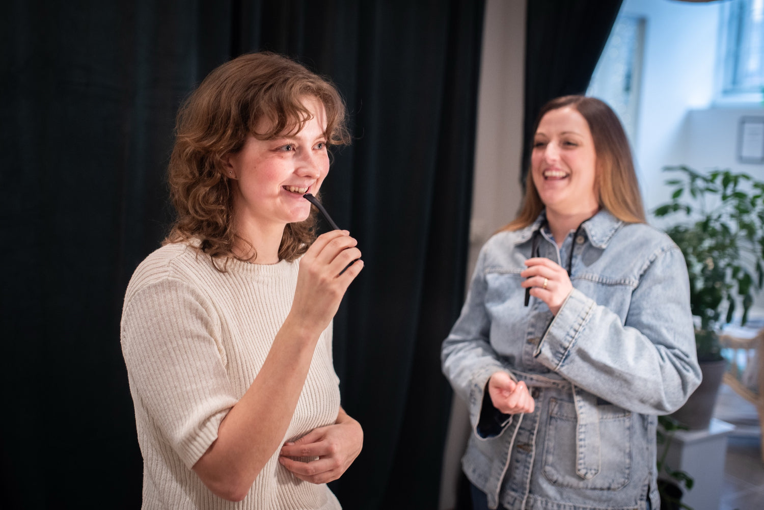 Two singers warming up by humming through their Zangger VoicePipes